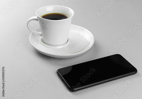 coffee Cup and smartphone on a blue background.