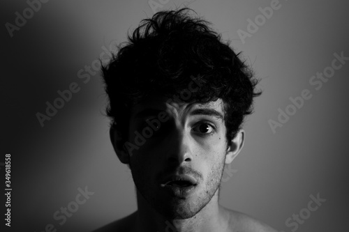 Cry shocked angry man curly hair shadows light black and white