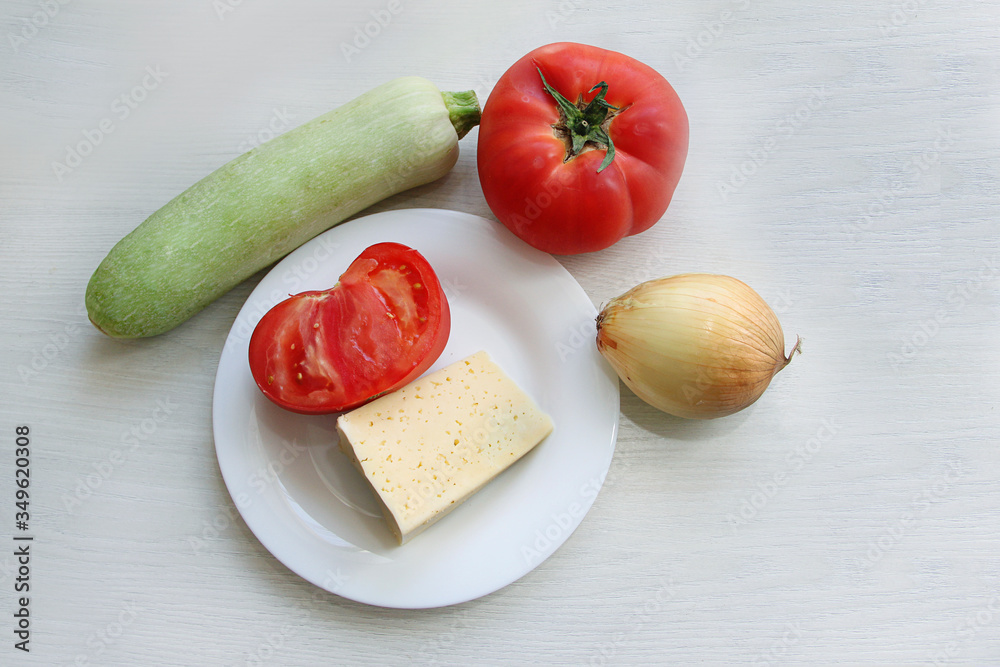 fresh vegetables, zucchini, tomato, onion, cheese, for cooking meals for proper nutrition fresh vegetables, zucchini, tomato, onion, cheese, for cooking meals for proper nutrition