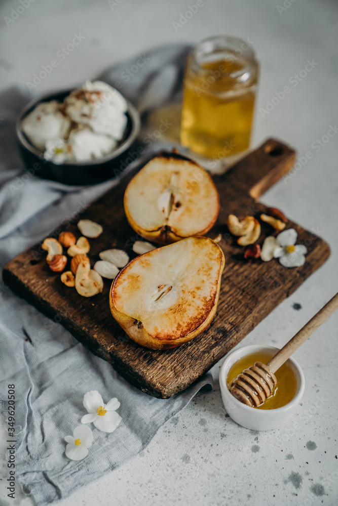 Baked Pears With Honey, Walnuts, Almond microgreens And flowers on a wooden board with Ricotta curd soft cheese Baked Pears With Honey, Walnuts, Almond microgreens And flowers on a wooden board with Ricotta curd soft cheese