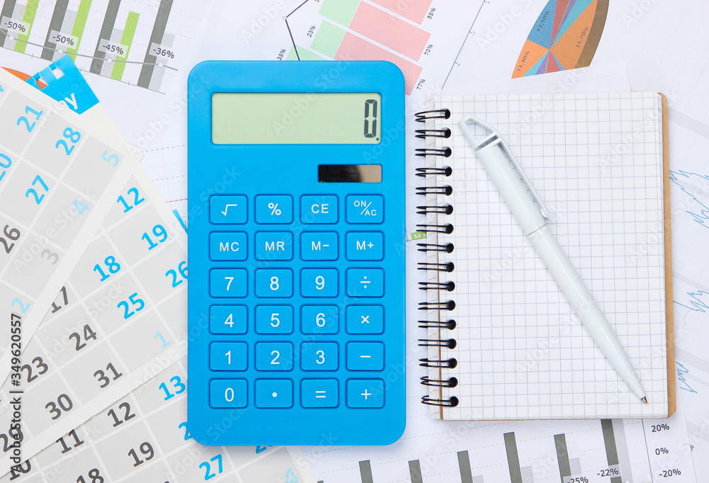 Calculator with notebook, graphs and charts, monthly calendar. Economic calculation, costing. Business and Finance Calculator with notebook, graphs and charts, monthly calendar. Economic calculation, costing. Business and Finance