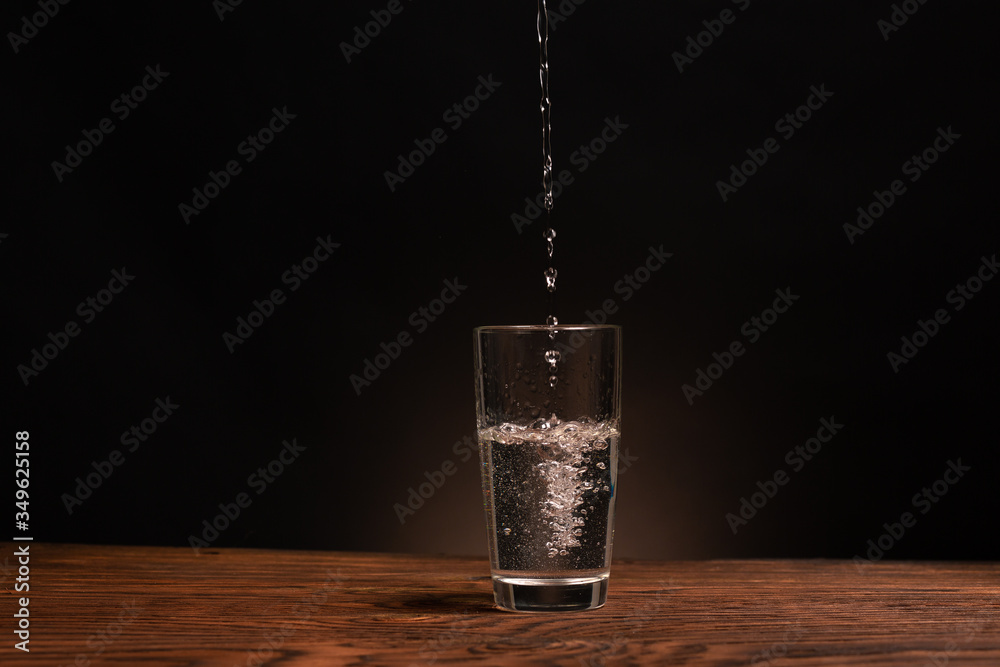 glass of pure water on dark background
