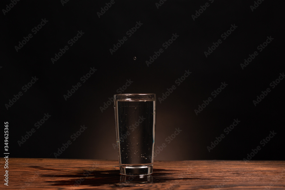 glass of pure water on dark background