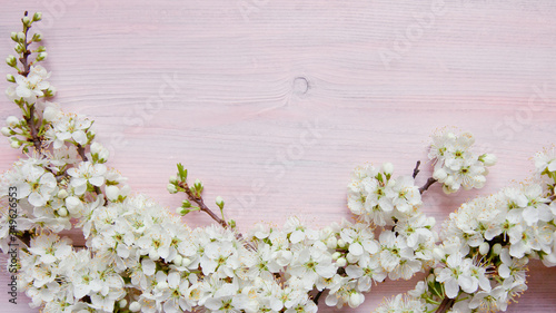 Plum flowers on a wooden background