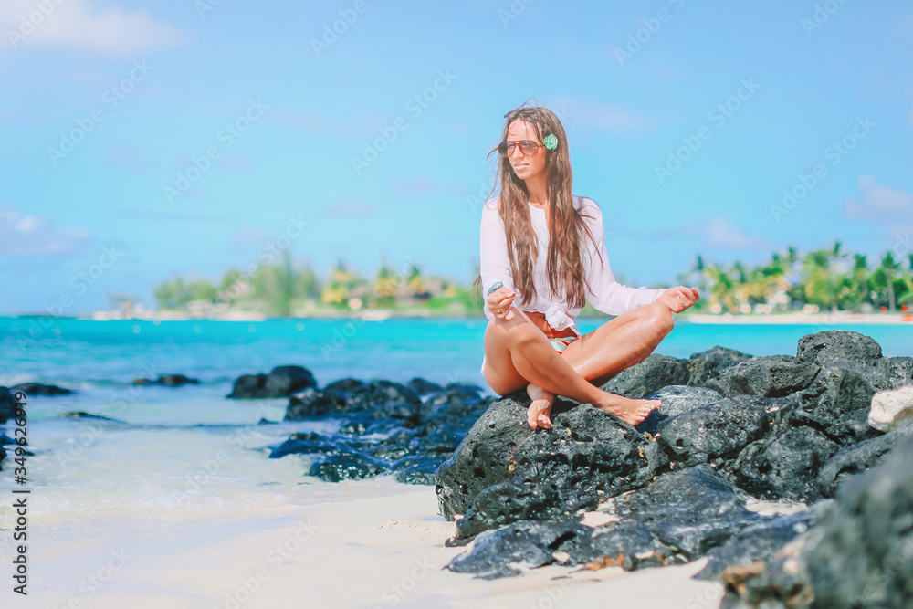 Beautiful girl in yoga position during tropical vacation Beautiful girl in yoga position during tropical vacation
