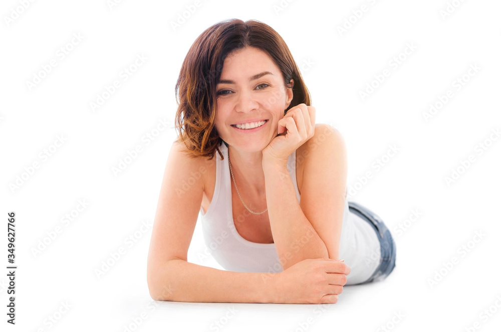 Beautiful smiling young woman lying on a floor isolated on a white background Beautiful smiling young woman lying on a floor isolated on a white background