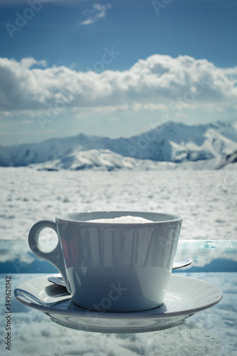 A cup of coffee against the backdrop of the mountains