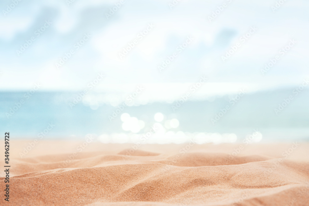 Tropical summer sand beach and bokeh sun light on sea background, copy space.