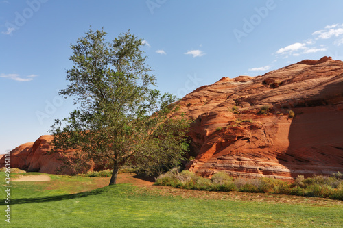 Green lawn and hill from red sandstone photo