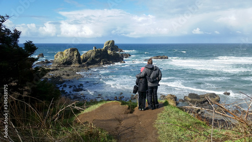 A father and son stand on a precipice in Oregon overlooking the Pacific Ocean Royalty free stock photo