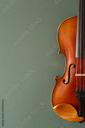 Classical music concert poster with brown color violin on dark green background with copy space for your text

