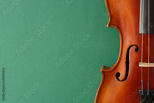 Classical music concert poster with brown color violin on dark green background with copy space for your text
 photo