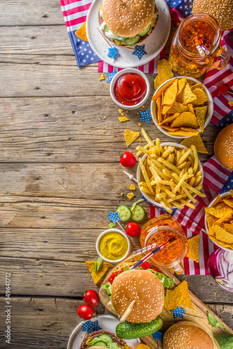 Celebrating Independence Day, July 4. Traditional American Memorial Day Patriotic Picnic with burgers, french fries and snacks, Summer USA picnic and bbq concept, Old wooden background