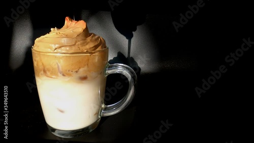 Dolgano coffee interfere with spoon glass transparent cup on black background natural light sunshine photo