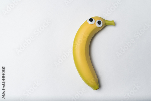 Banana with Googly eyes on white background. Banana character. Copy space