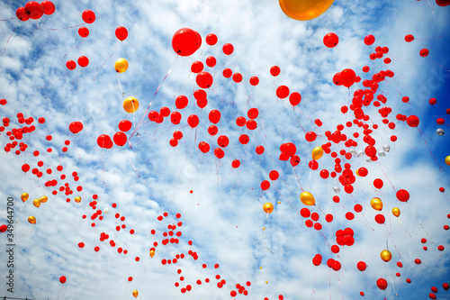 Red balloons flying into the sky