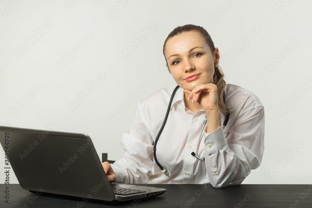 beautiful young woman at a table with a laptop beautiful young woman at a table with a laptop