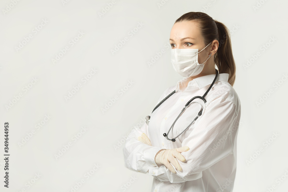 beautiful young woman in medical face mask on a white background
beautiful young woman in medical face mask on a white background