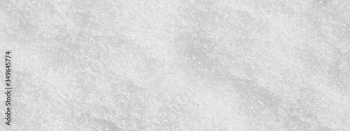 Black and white snow texture closeup, top view. Gray background, panorama, banner with place for text.