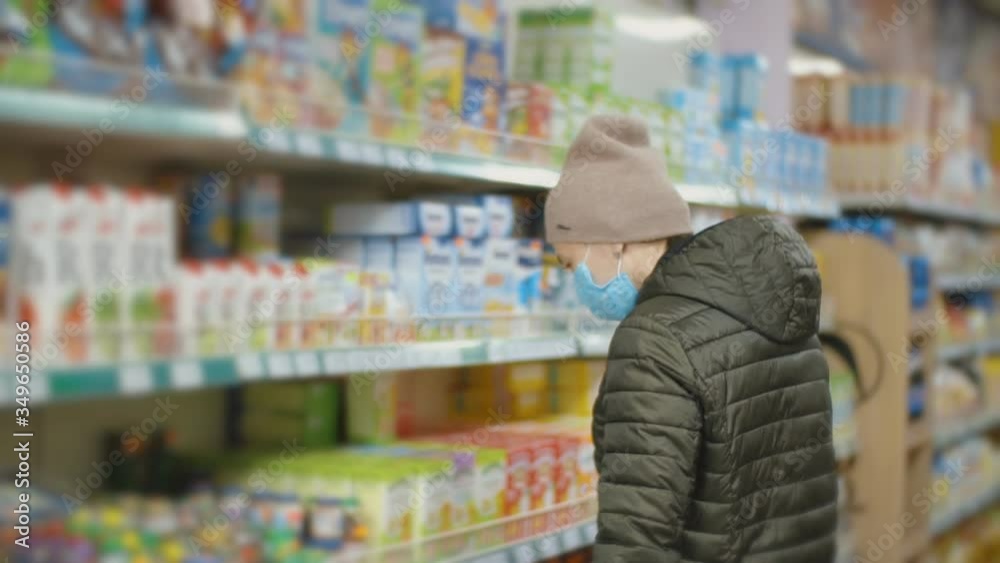 woman in medical mask chooses products woman in medical mask chooses products