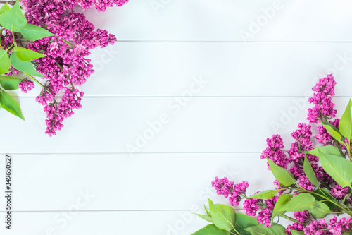 frame with a bouquet of purple lilacs. the background with lilac branches lay flat. lilac copy space.
