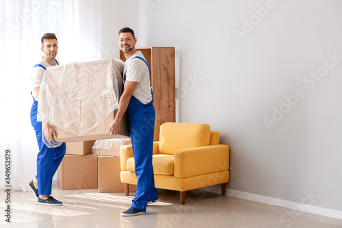 Loaders carrying furniture in flat © Pixel-Shot