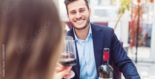 Man and woman enjoying a glass of red wine with their meal