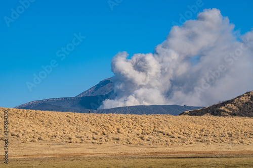 Kusasenri prairie in January, fuming Mt. Naka (also called Nakadake or Naka-Dake) in the background. Aso Kuju National Park, Kumamoto Prefecture, Japan