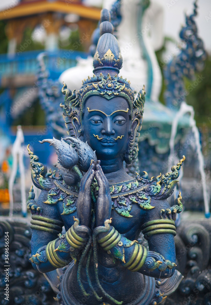 Blue statue of the Guard in Thai Lanna style - detail of exteror of Wat Rong Suea Ten, or Blue Temple in Chiang Rai Province, Northern Thailand