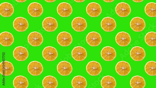 Seamless Pattern with lemon fruit slices on green color background.