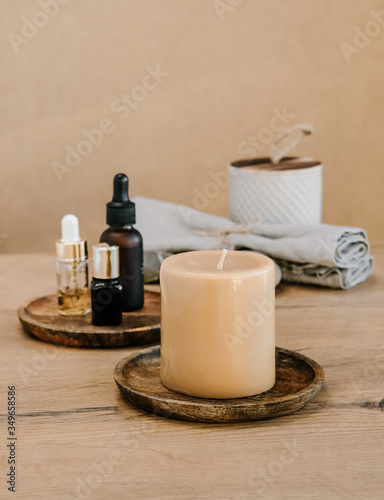 Aroma candles and essential oils on brown background. Spa beauty concept. 