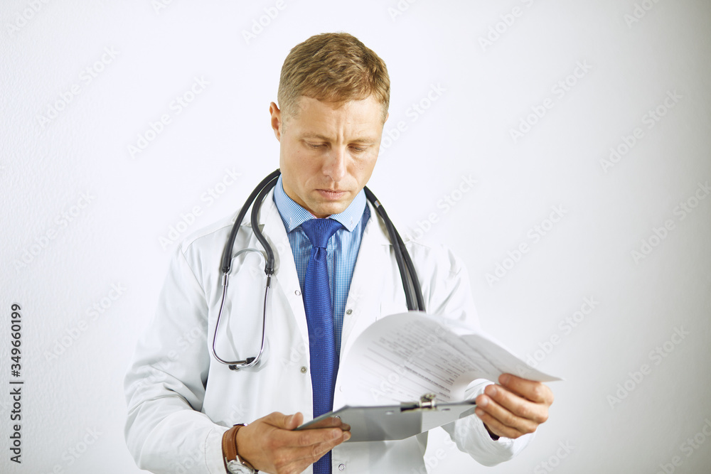 Young confident doctor in a white coat with a stethoscope Young confident doctor in a white coat with a stethoscope