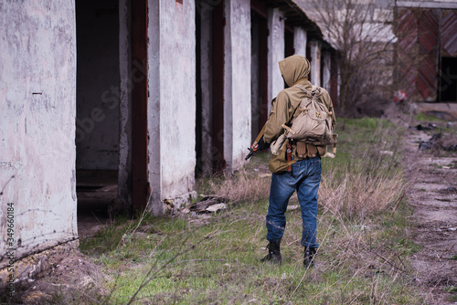 Armed stalker warrior inspecting destroyed building