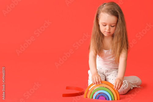 Little girl with toy on col...