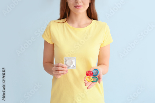Young woman with condoms on...