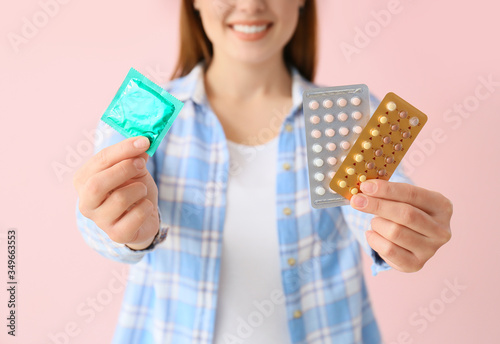 Young woman with condom and...