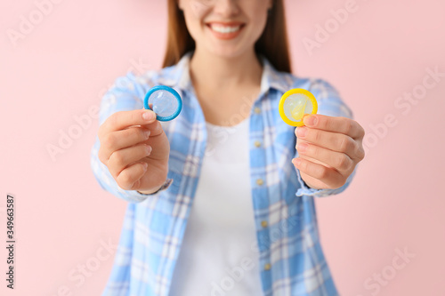 Young woman with condoms on...