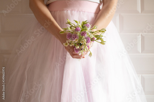 Bridesmaid with a bouquet of wildflowers