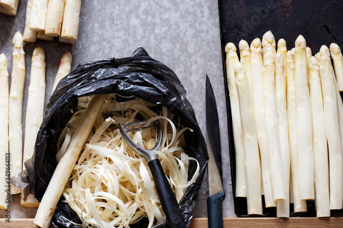 Peeling white asparagus, raw for cooking  