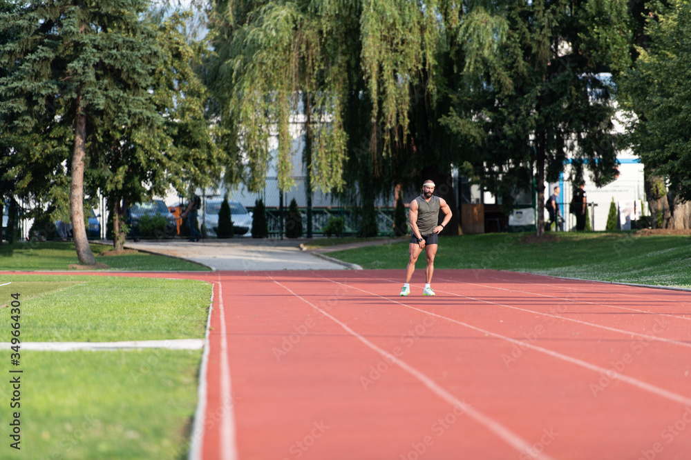 Portrait of Sporty Man on Running Track