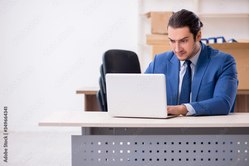 Young male employee in relocation concept Young male employee in relocation concept