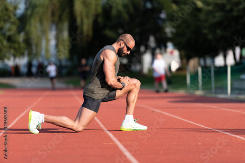 Young Fitness Man Runner Stretching Legs Before Run