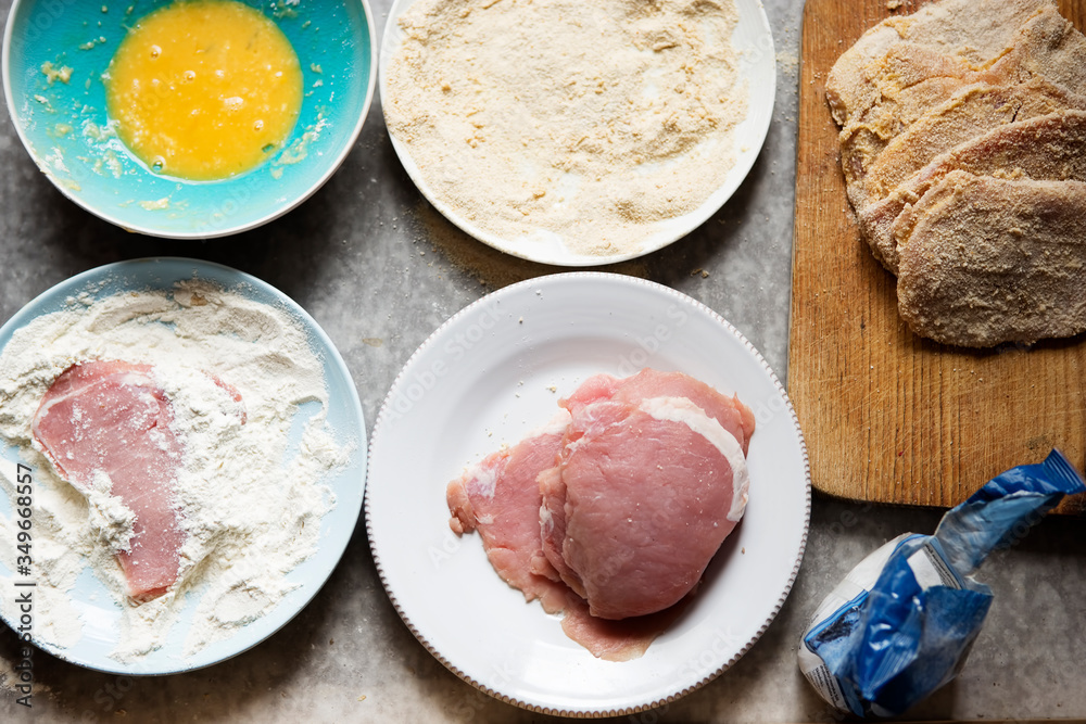 Preparing breaded pork chops, polish kotlety. Flour, whisked egg, bread crumbs. Preparing breaded pork chops, polish kotlety. Flour, whisked egg, bread crumbs.