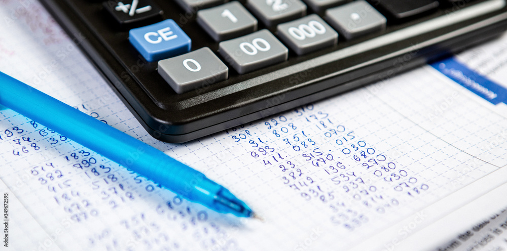 Pen and calculator. Background Items for doing business in the office in the composition. Pen and calculator. Background Items for doing business in the office in the composition.
