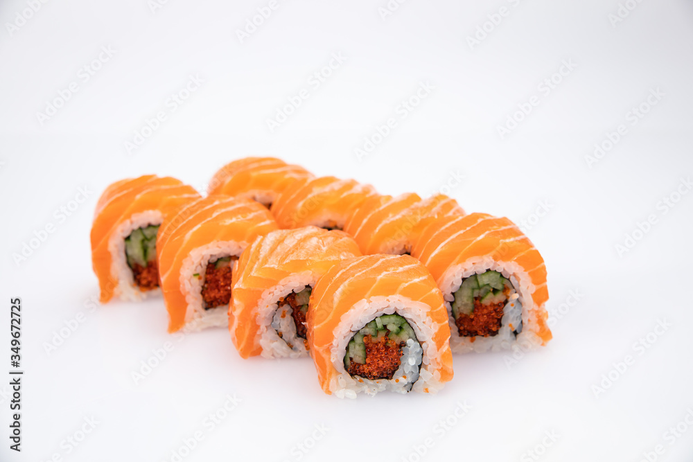 Japanese cuisine. Sushi roll with salmon on white background.