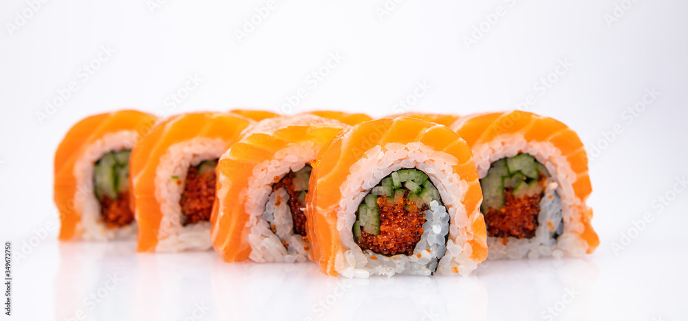 Japanese cuisine. Sushi roll with salmon on white background. Japanese cuisine. Sushi roll with salmon on white background.