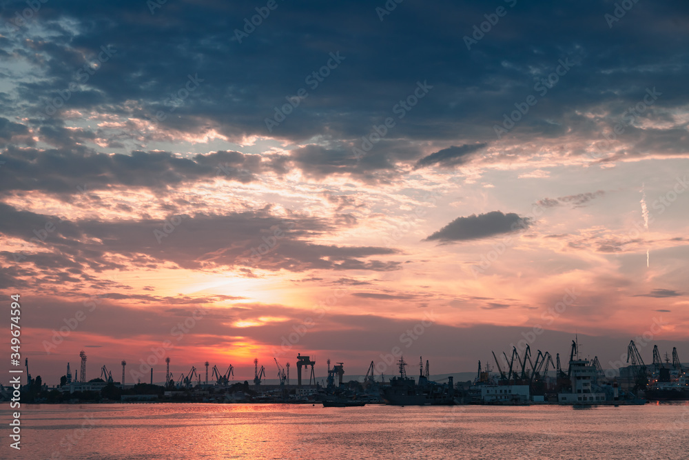 Varna port at sunset. Dark silhouettes of cranes