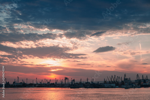 Varna port at sunset. Dark silhouettes of cranes