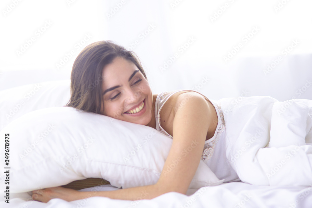 beautiful young woman basking in bed in the morning. Beautiful Model face looks sexy in camera beautiful young woman basking in bed in the morning. Beautiful Model face looks sexy in camera