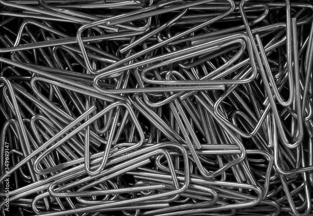 triangular metal paper clips creating a conceptual office background triangular metal paper clips creating a conceptual office background